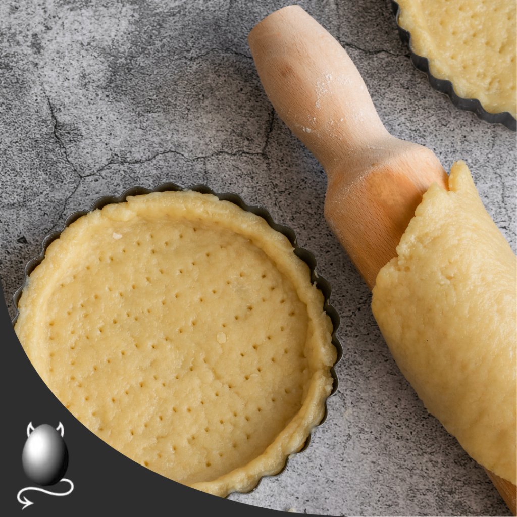 short crust pastry with a rolling pin and tart tin